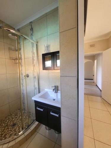 a bathroom with a sink and a shower at Generosa of the North in Durban
