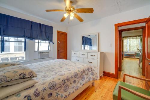 a bedroom with a bed and a ceiling fan at Wildwood Apartment - Porch and Enclosed Sunroom! in Wildwood