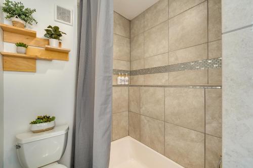 y baño con ducha, aseo y bañera. en Modern Meadow Vista Vacation Home with Spacious Deck, 