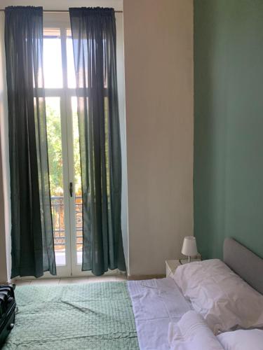 a bedroom with a bed and a sliding glass door at GARIBALDI ROOMS in Reggio Calabria