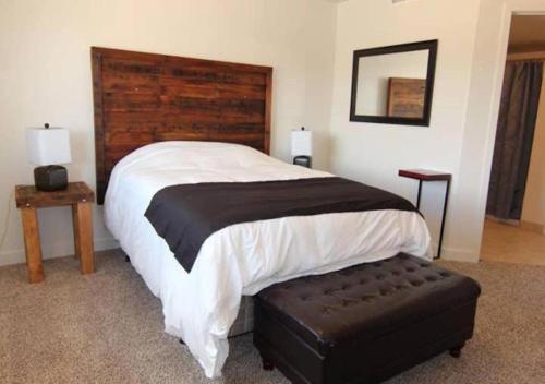 a bedroom with a large bed with a wooden headboard at Moab Oasis in Moab