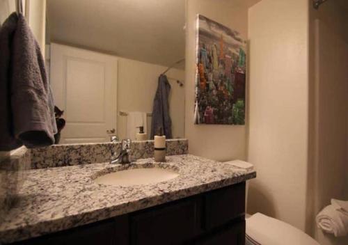 a bathroom with a sink and a mirror at Moab Oasis in Moab