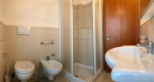 a bathroom with a shower and a toilet and a sink at Bibione MasterVillage Family in Bibione