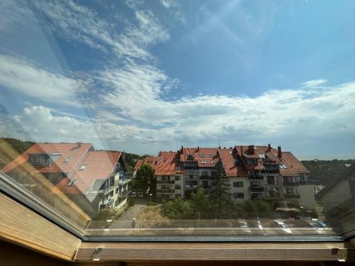 a view of a city from a window with buildings at Nida Oasis Apartment in Nida