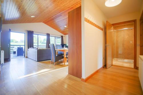 an open living room with a table and chairs at Glenview Chalet Park in Inverness