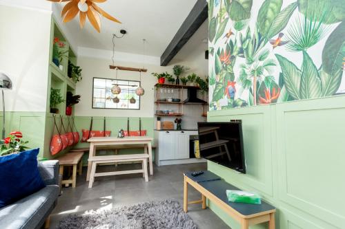 a living room with a couch and a table at 1 The Old Schoolhouse for 5+cot; hot tub, parking, pets in Whitstable