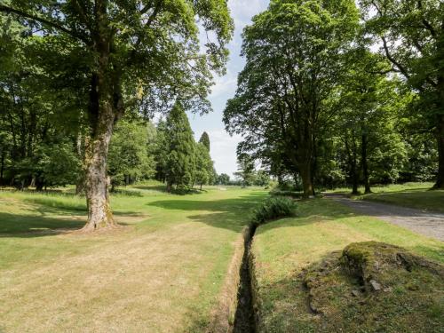 a path in a park with trees and grass at The Mews Flat in Dalswinton