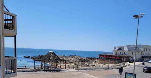 Una vista de la playa y el océano desde un edificio. en Le Belvédère de Port-Lin - Les Gîtes de la Côte d'Amour, en Le Croisic