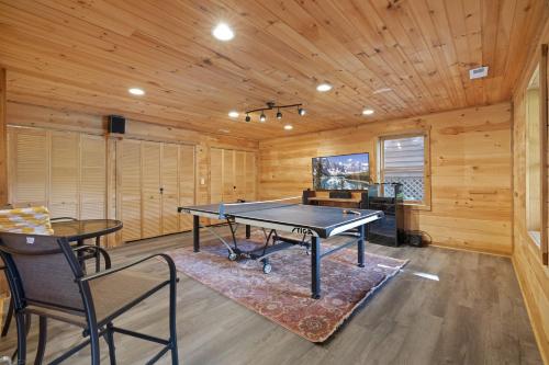 a ping pong table in a room with wooden walls at Good Dog Dreams in Valle Crucis