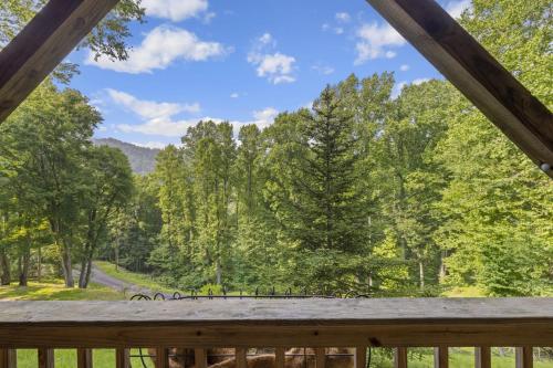 a view from the deck of a cabin with trees at Good Dog Dreams in Valle Crucis