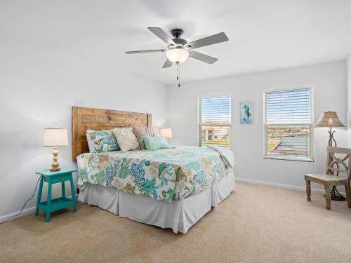 a bedroom with a bed and a ceiling fan at Bay Breeze Bungalow in Rockport