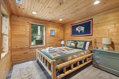 a bedroom with a bed in a log cabin at Good Dog Dreams in Valle Crucis