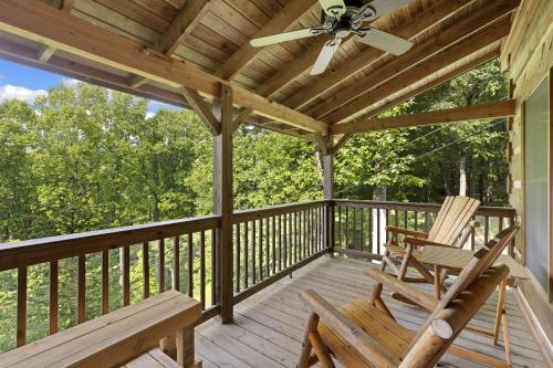 a porch with two chairs and a ceiling fan at Good Dog Dreams in Valle Crucis
