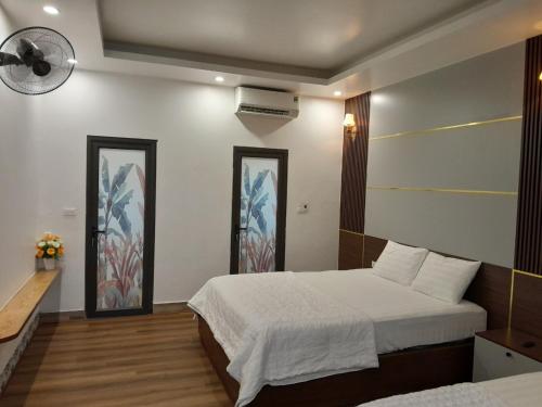 a bedroom with a bed and two mirrors at Amazing View Homestay in Ninh Binh