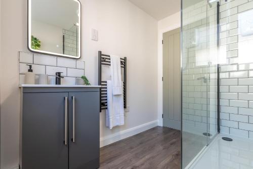 a bathroom with a sink and a shower at Must See Vibrant Contemporary Two Bed Apartment in Leicester