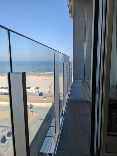 a balcony of a building with a view of the beach at Studio Sun south- seaview-sea at 15meter-Ostend in Ostend