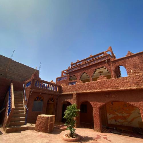 an old brick building with a tree in front of it at Maroc Galacx in Ouarzazate