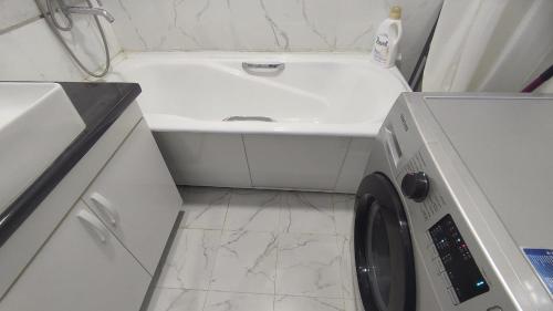 a washing machine in a bathroom with a sink at Красивая квартира в центре города. in Dushanbe