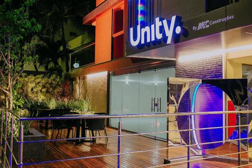 a building with a table in front of it at Unity #110 - Apartamento ao mar por Carpediem in Penha