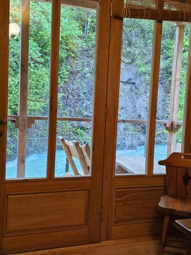 two windows in a room with a door at inSxvava in Ambrolauri