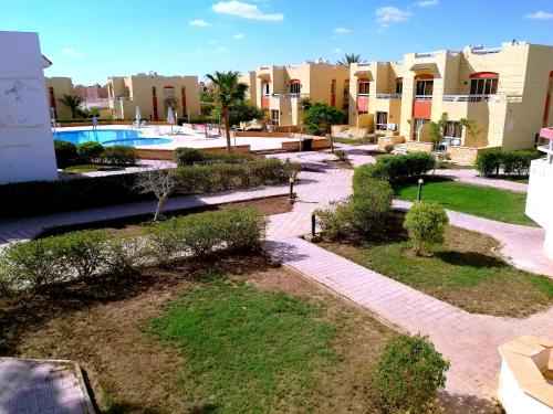 a resort with a swimming pool and some buildings at فيلا رائعة في منتجع سانتا مونيكا مرسي مطروح عائلات فقط in Marsa Matruh