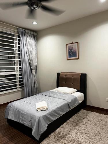 a bedroom with a bed with a ceiling fan at Zetapark, The Loft in Kuala Lumpur