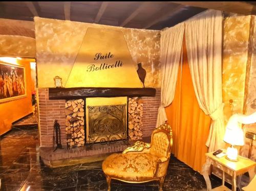 a living room with a fireplace and a chair at SUITE BOTTICELLI in Albavilla