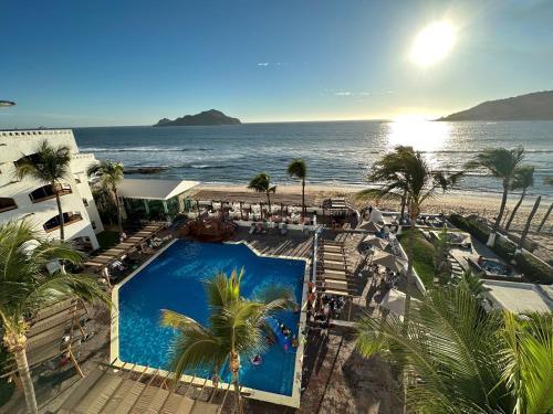 a view of the beach from a resort with a swimming pool at Hotel Quijote Inn in Mazatlán
