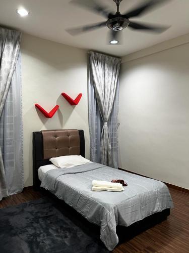 a bedroom with a bed with red shoes on the wall at Zetapark, The Loft in Kuala Lumpur