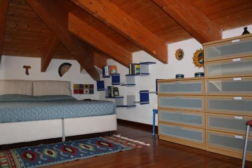 a bedroom with a bed and a dresser at La Bici Bianca in Imperia