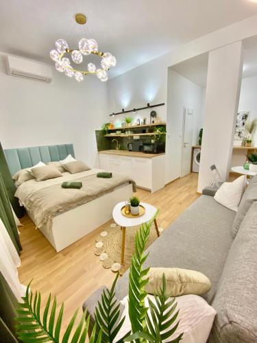 a living room with a bed and a couch at BRAND NEW Design studio Emerald - old town A/C in Bratislava