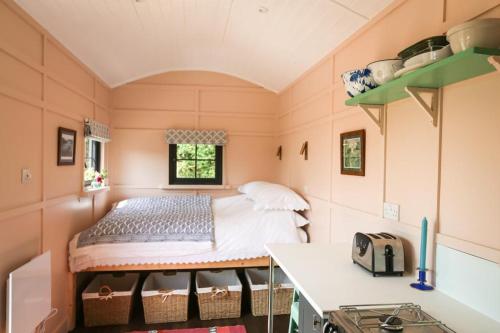 a small room with a bed and a table at Lapin Cottage in Long Bredy