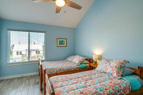 a room with two beds and a window at Bright Key Allegro Condo with Community Outdoor Pool in Rockport