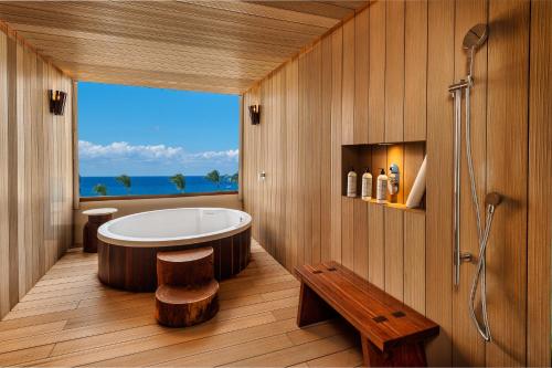 a bathroom with a tub and a view of the ocean at Presidente InterContinental Cozumel Resort & Spa, an IHG Hotel in Cozumel