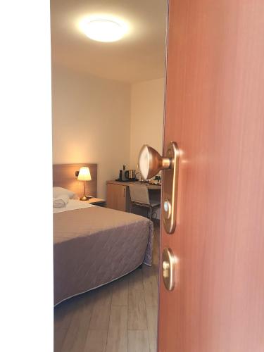 a door to a bedroom with a bed and a desk at RipamontiBnB in Milan