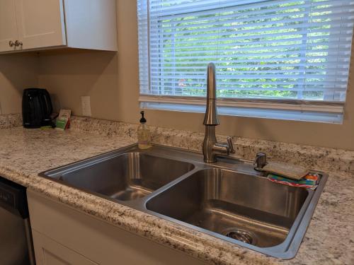 a stainless steel sink in a kitchen with a window at Peaceful North Durham Retreat, 3Bd in Durham