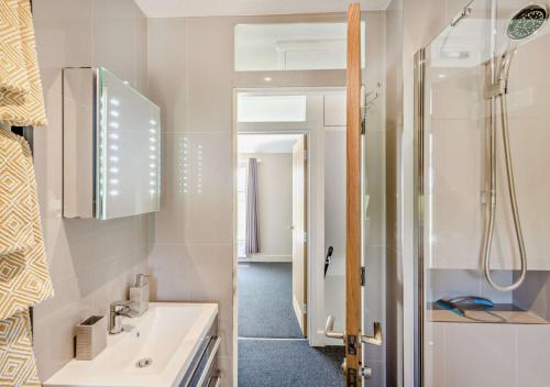 a bathroom with a sink and a shower at Swallows Return - Colkirk in Colkirk