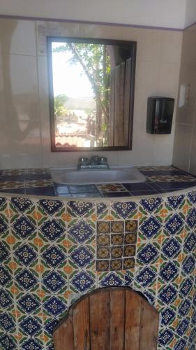 a bathroom with a tile counter with a sink at Shambhala Visión in Zipolite