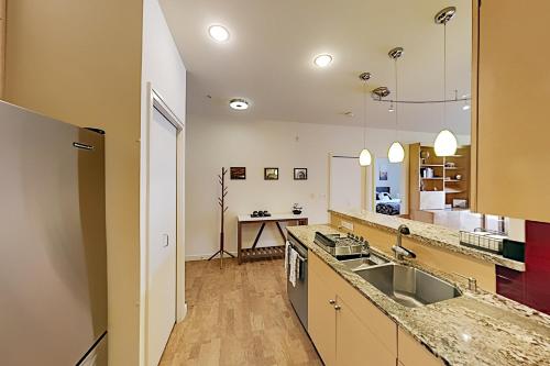 a large kitchen with a sink and a counter at Downtown Dreaming in Seattle