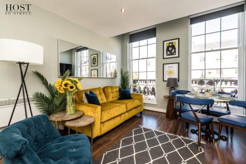 a living room with a yellow couch and a table at Host & Stay - Canning Quarters in Liverpool