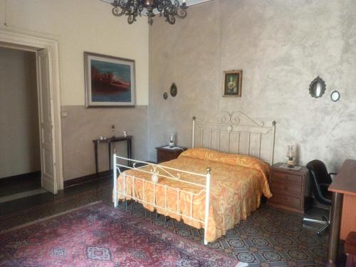 a bedroom with a bed with an orange bedspread at Gatti al Borgo in Catania