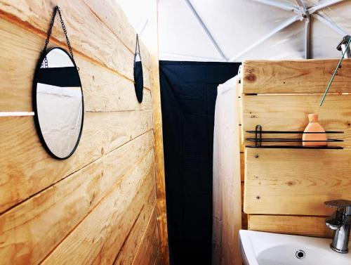 a bathroom with a mirror and a sink at Stone Rose Glamping & Apartments in Tivat