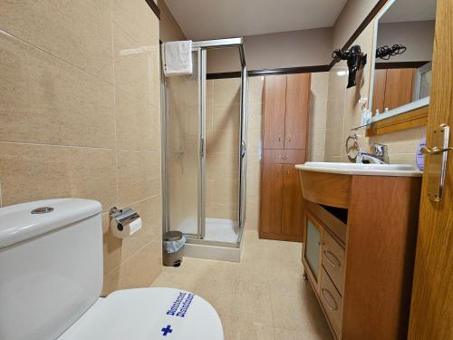 uma casa de banho com um chuveiro, um WC e um lavatório. em 13B01 Apartamento con terraza y garaje em Ribadesella