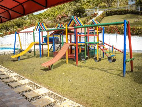 a playground with colorful equipment in a park at CABAÑA Y RESTAURANTE CAMPESTRE EL MIRADOR COSTEÑO in Turbo