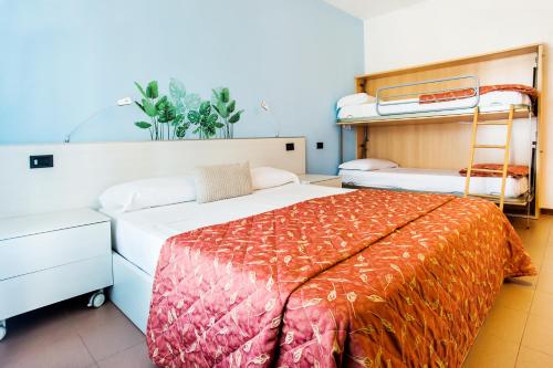 a bedroom with a bed and bunk beds in it at Hotel Il Castello in Pozzolengo
