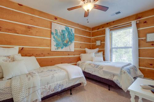 a bedroom with two beds and a ceiling fan at Jemez Springs Cabin with Deck and Mountain Views! in Jemez Springs