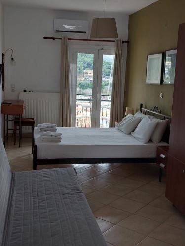 a bedroom with a large bed and a window at Marthas Studios in Parga