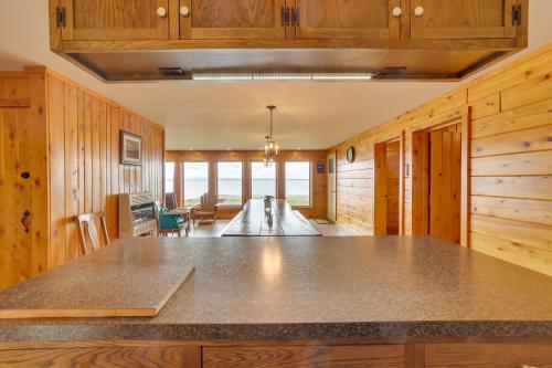 a kitchen with a large island in a room with wooden walls at Lake Champlain Vacation Rental with Boat Dock! in Melville Landing