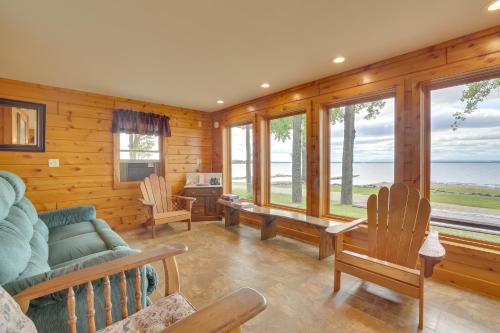 a living room with a couch and chairs and windows at Lake Champlain Vacation Rental with Boat Dock! in Melville Landing