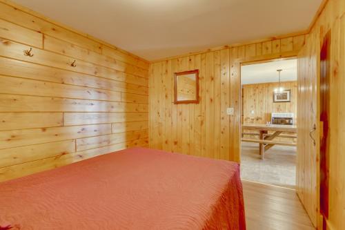 een slaapkamer met houten wanden en een bed in een kamer bij Lake Champlain Vacation Rental with Boat Dock! in Melville Landing